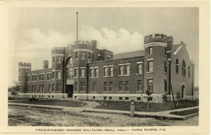 Carte postale ancienne du manège militaire de Trois-Rivières peu après sa construction, vue de l’angle des rues Saint-François-Xavier et Sainte-Geneviève.